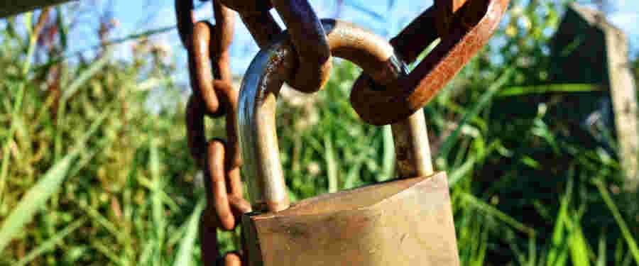 not fully secure - padlock on a gate